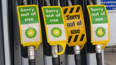Signs warn drivers that gas pumps are out of order.
