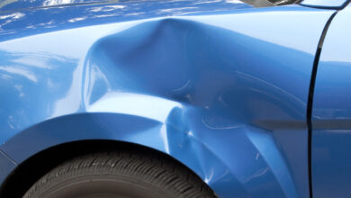 Auto accident leaving a huge dent in the left front quarter panel.