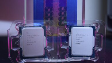 Two Intel processors, the Core i9-14900K and the Core i5-14600K, are displayed in their packaging against a blurred background of a processor wafer.